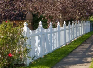 two workers installing a wooden fence two workers installing a wooden fence